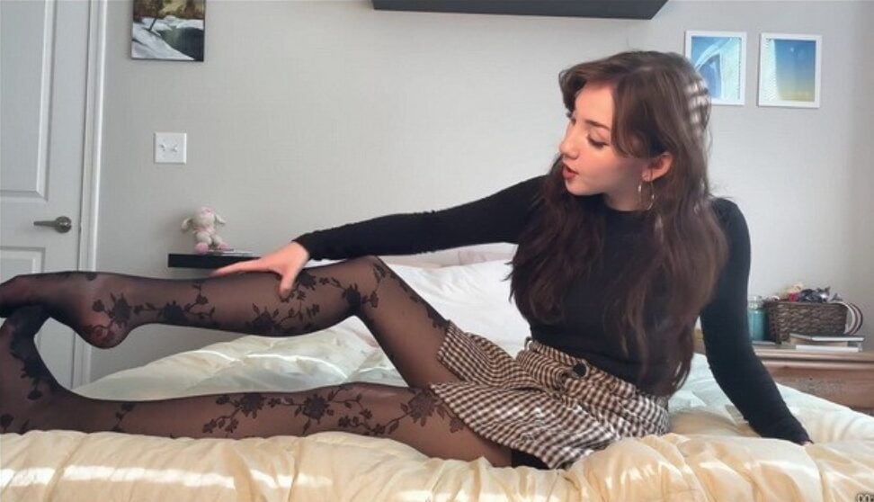 LookBook | A Chinese-American girl tries on two different black stockings on the bed