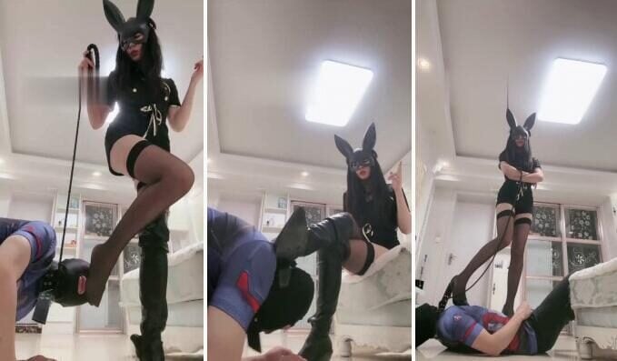 ユエインガー黒いストッキング、ハイヒール、ロングブーツを履いたバニーガールが犬を踏んでいる