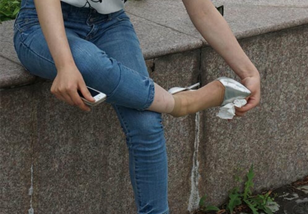 Free photography | Choosing shoes is the daily action of the girl in short stockings