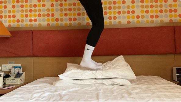 Amateur music department girl | White socks and sneakers stepping on pillow